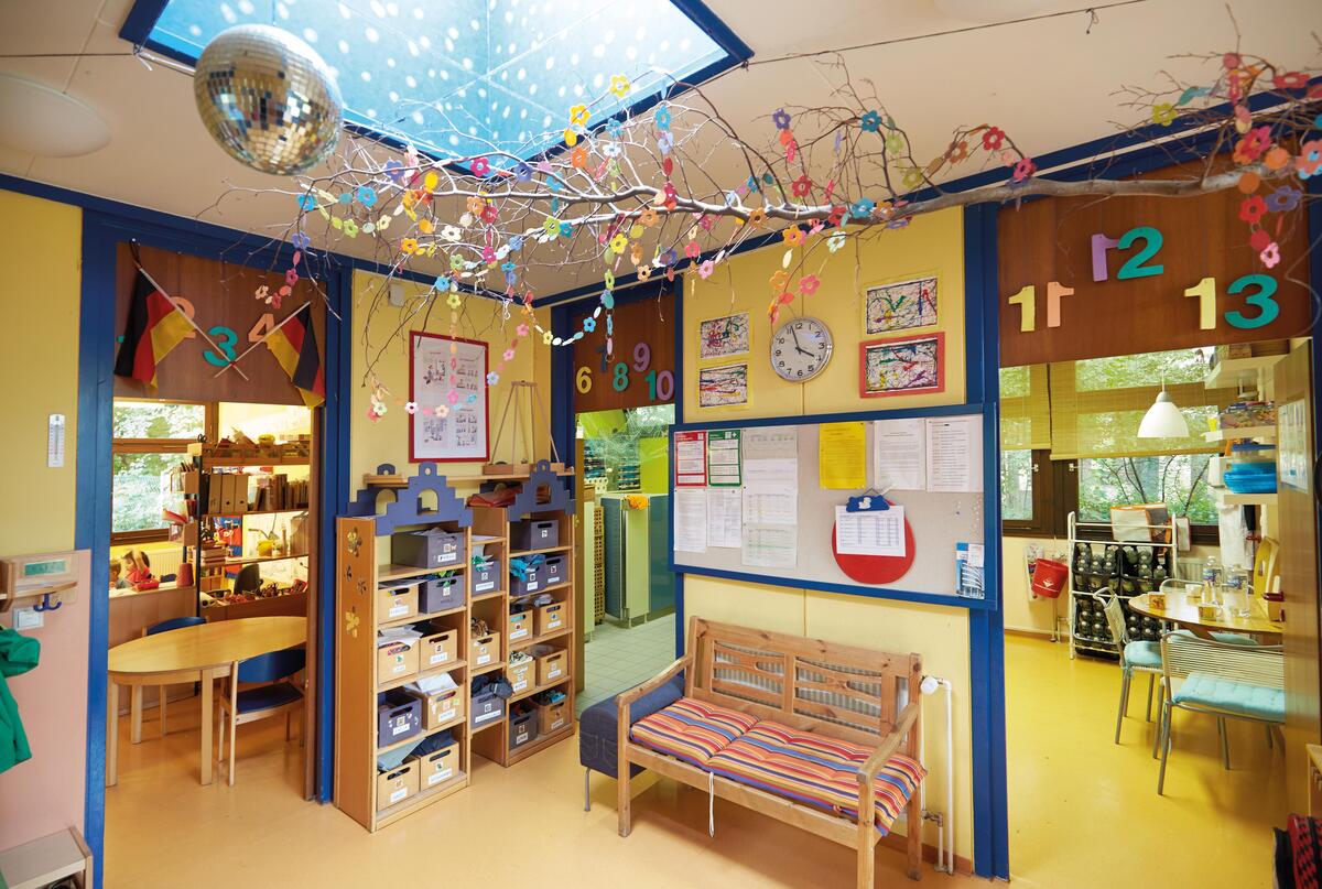 View from the hallway with checkroom into the rooms of the children's house Uni-Kids