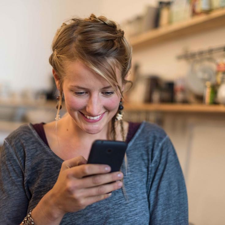Young woman looking at her mobile phone 