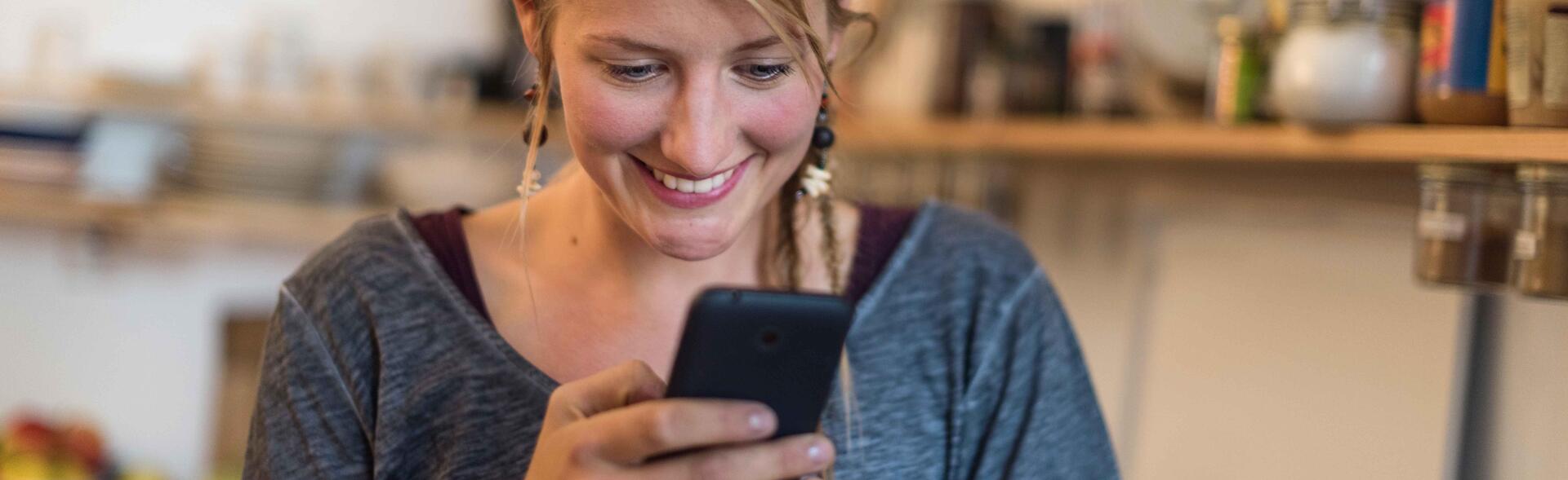 Young woman looking at her mobile phone 