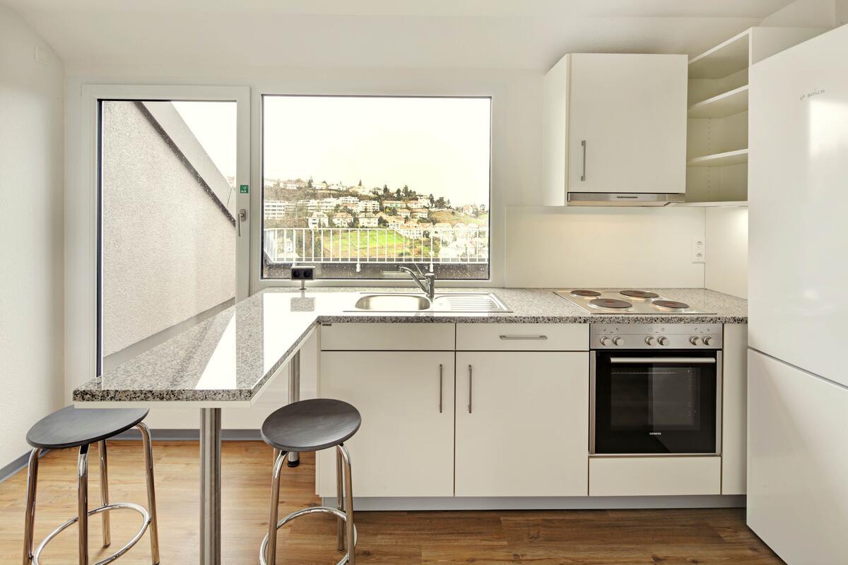 Kitchen with dining table and chairs in the dormitory in Birkenwaldstraße 