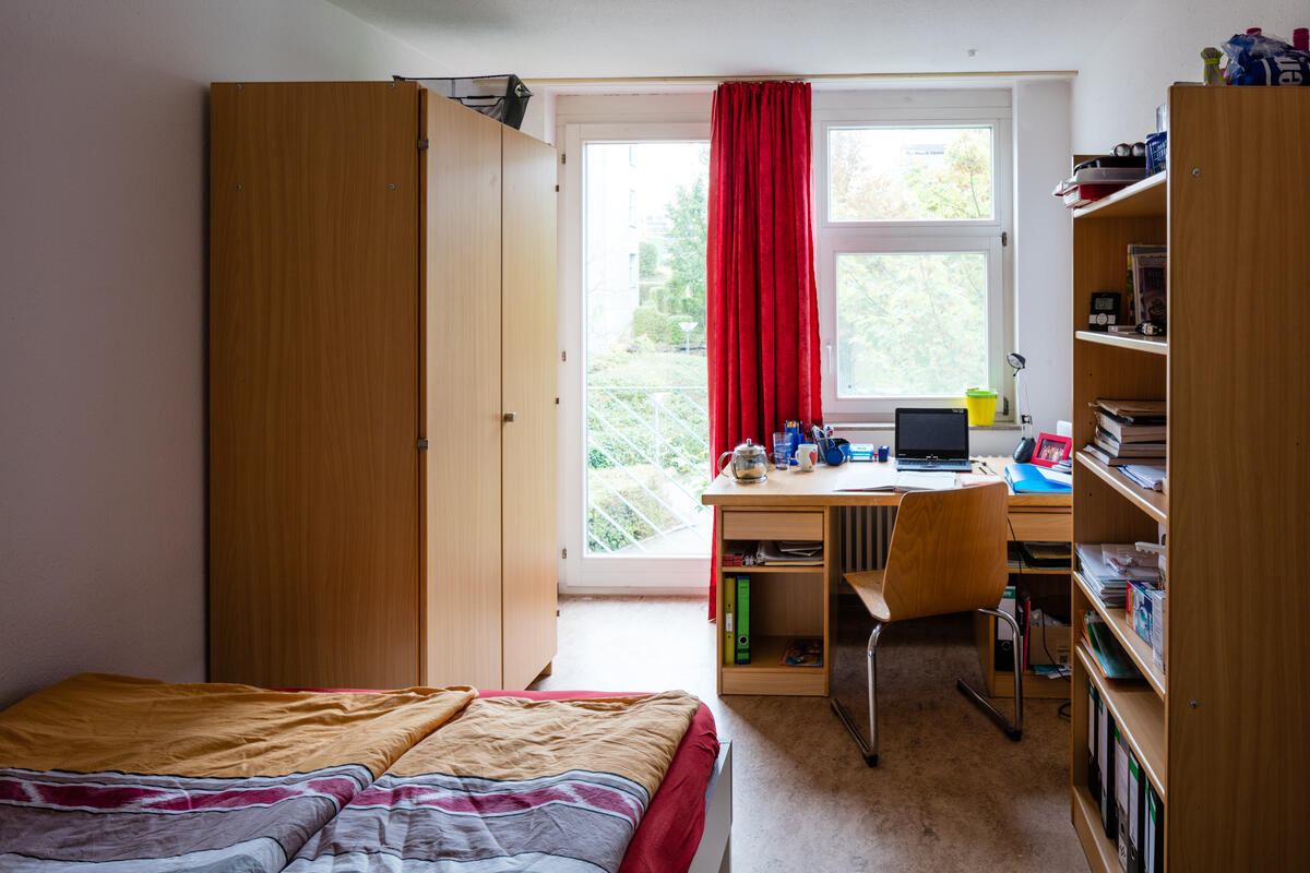 Room with bed, wardrobe and desk in Allmandring 3
