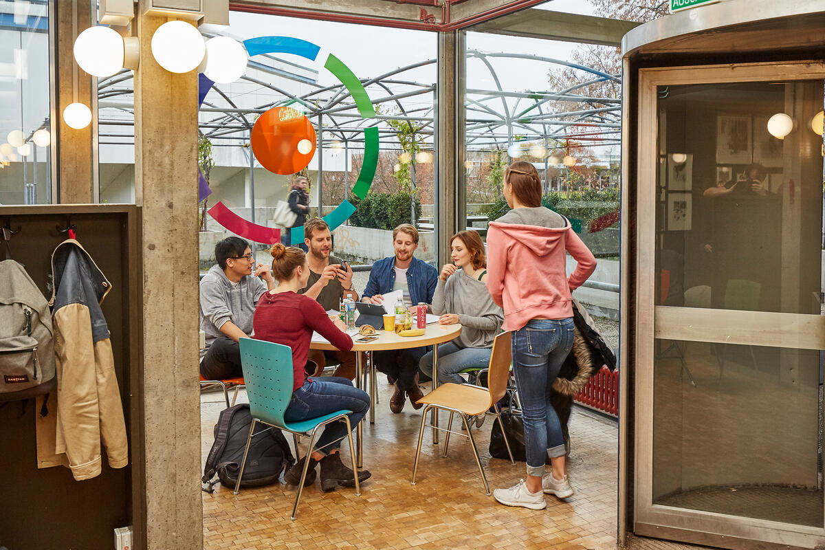 Students sit together at the table and talk