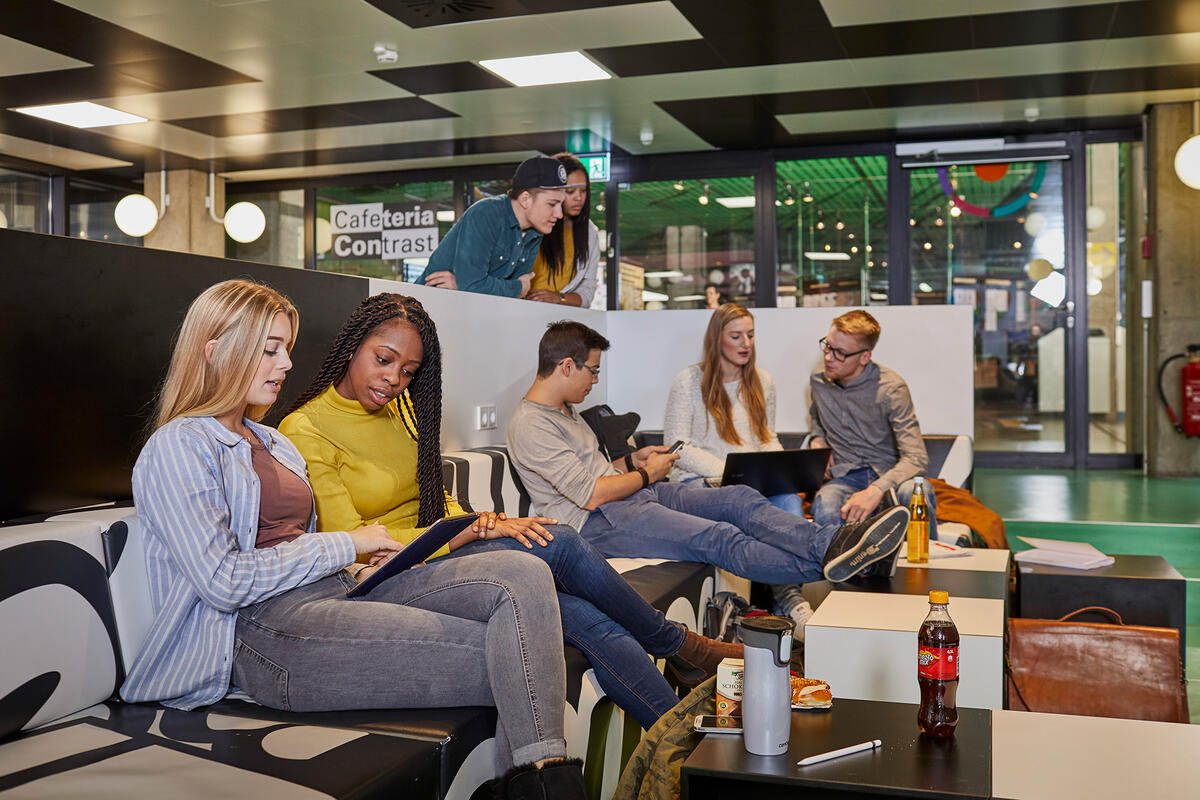 Students hang out at the seating area of the Contrast cafeteria