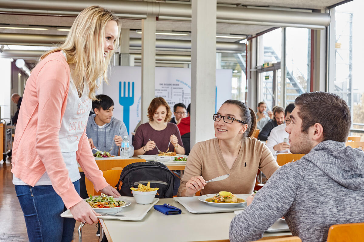 Students sitting in the dining hall of the Mensa Vaihingen having lunch