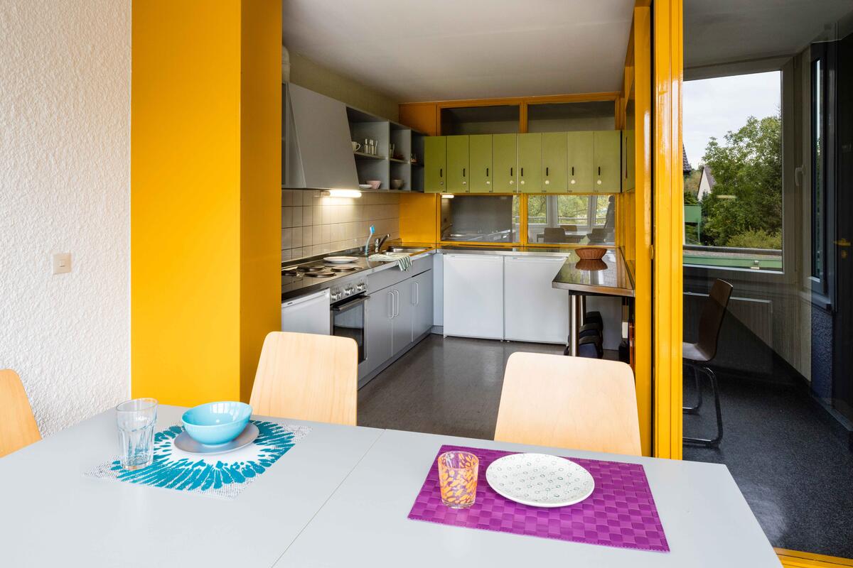 Kitchen with dining table and chairs in the dormitory of finance