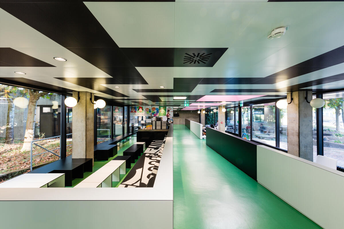 Interior with seating and aisle of the Contrast cafeteria