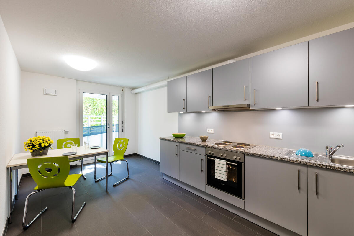 Kitchen with table and chairs in the dormitory at Rosensteinstraße