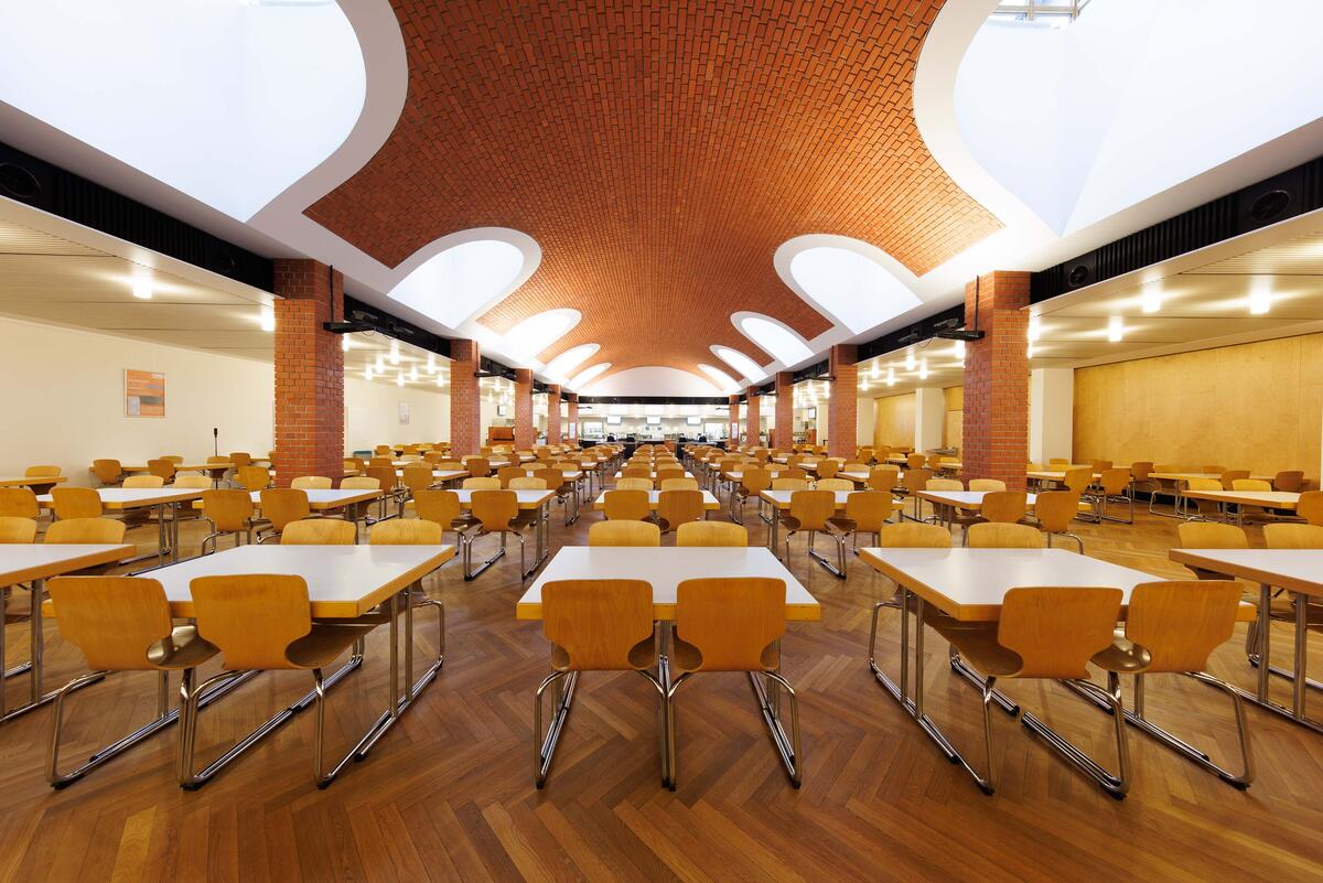 Dining hall of the Mensa Central with vaulted roof and skylight windows.